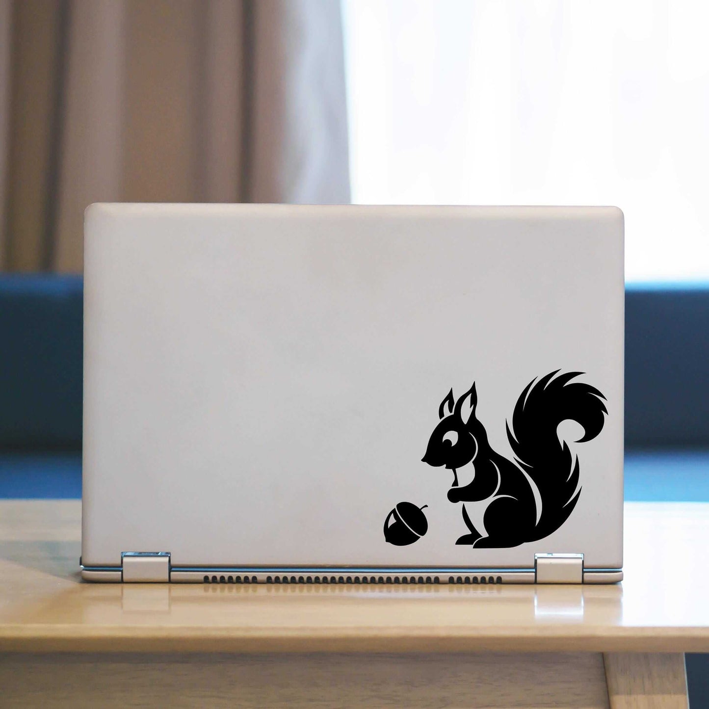 Squirrel Laptop Decal. Squirrel looking at acorn graphic.