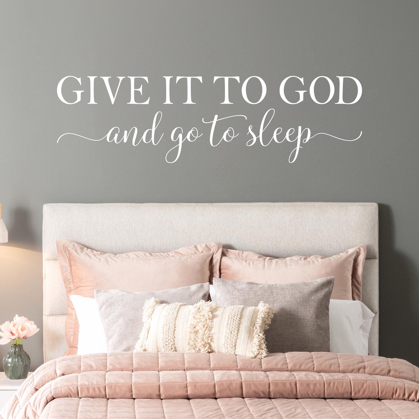 Inspirational Christian quote wall decal above a neutral-toned bed, perfect for a peaceful faith-filled bedroom. Give it to God and go to sleep quote.